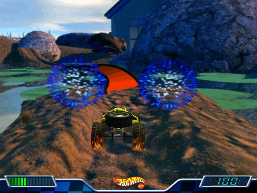 In a thrilling rush, the 2000 Hot Wheels - Stunt Track Driver 2 car zooms toward a luminous checkpoint with blue and orange lights on rocky terrain, mimicking real-life video game number tracking.