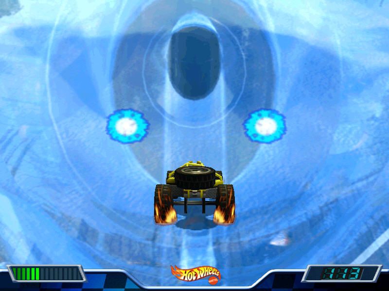A 2000 Hot Wheels - Stunt Track Driver 2 - GET N DIRTY game features a toy car racing on a blue icy track with glowing circular lights, akin to a spinning disc. Dashboard elements appear at the bottom of the screen.
