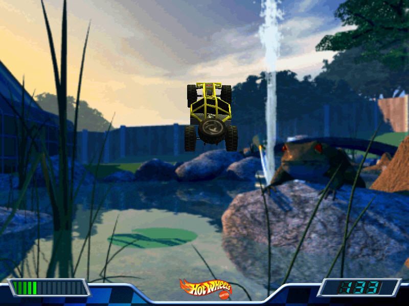 In 2000 Hot Wheels - Stunt Track Driver 2 - GET N DIRTY for PC, a toy car leaps over a pond as a frog watches, surrounded by digital game interface elements and the whirring sound of a disc.