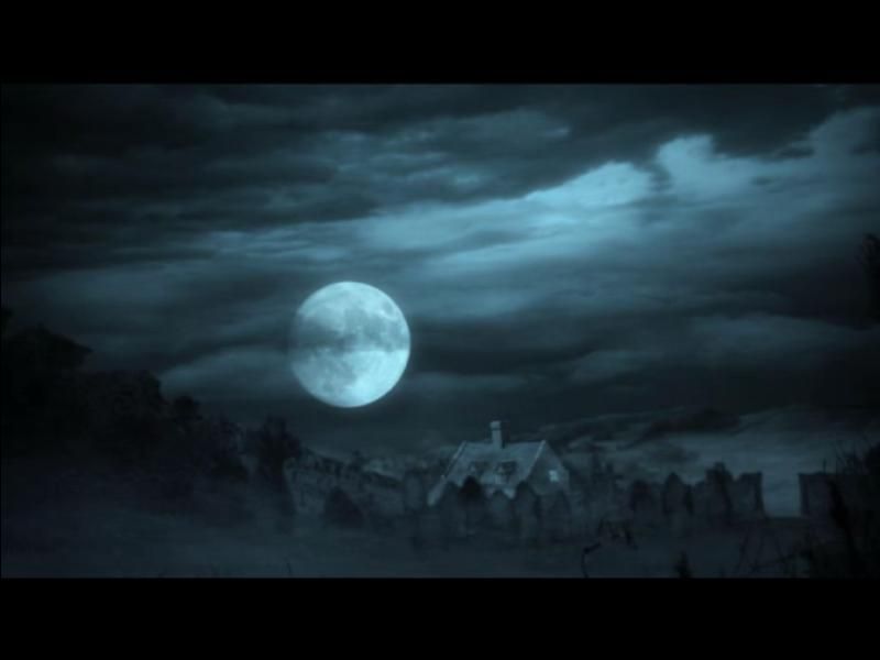 A full moon shines over a dark, cloudy night sky, its glow reminiscent of a Harry Potter And The Goblet Of Fire Microsoft Windows PC CD illuminating a seemingly abandoned building shrouded by trees and fog.