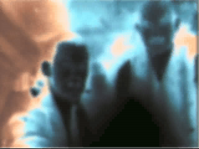 Two figures stand in a surreal, color-inverted image on the paper sleeve of Johnny Mnemonic Disc 1 - 2 for Microsoft Windows PC CD, creating an impression of abstract art.