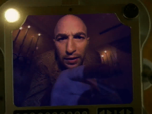 On screen, a person leans in, pointing at the camera like Johnny Mnemonic Disc 1-2 Microsoft Windows PC CD in a paper sleeve. A dimly lit background flickers with candlelights warm glow thats beyond USPS shipping replication.
