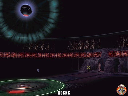 Futuristic room featuring a glowing circular ceiling light resembling The Ward Microsoft Windows PC CD, with patterned walls, platform floor, rock formations, and an entrance. ROCKS is written at the bottom, creating a sci-fi adventure vibe.
